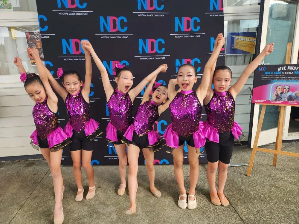 Team in sequinned costumes at NDC
